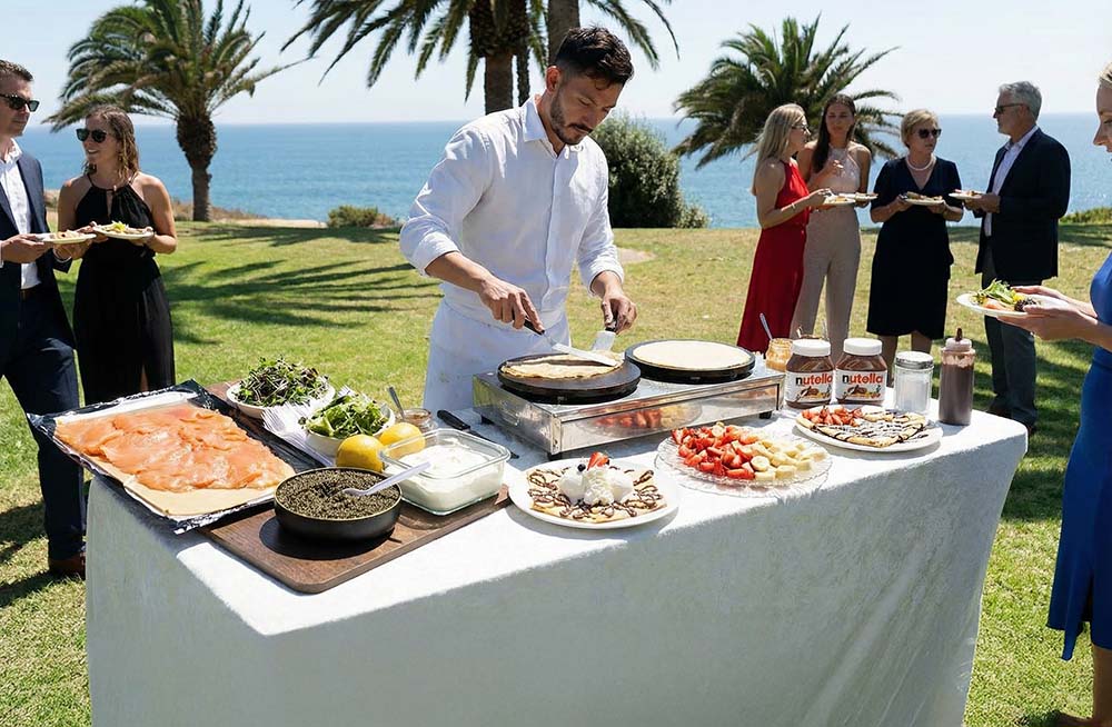 Guests enjoying a crêpe catering station with smoked salmon and caviar